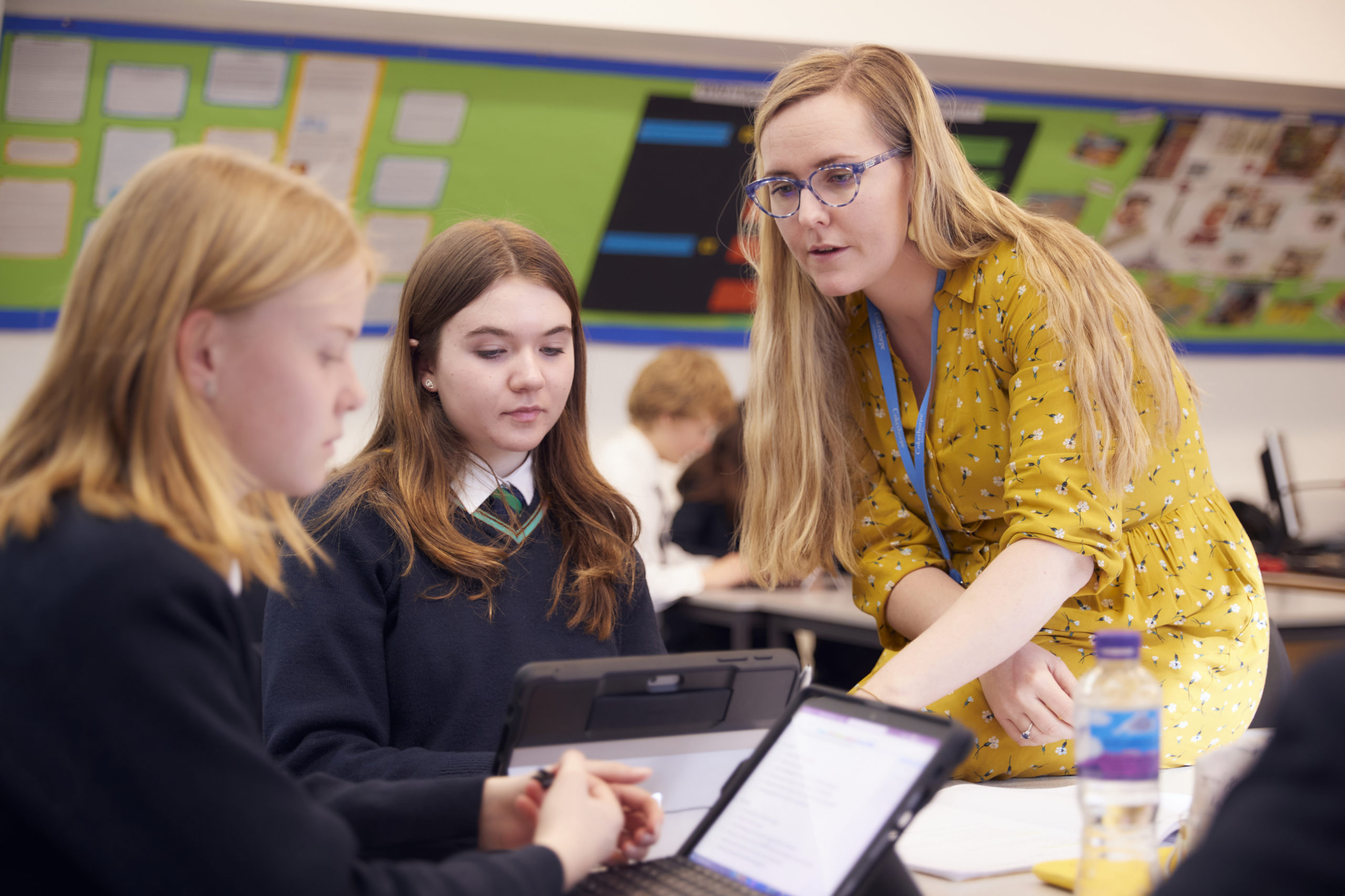 Female teacher teaching pupils in class - Individual Focus - Digital Learning - An Independent Day School