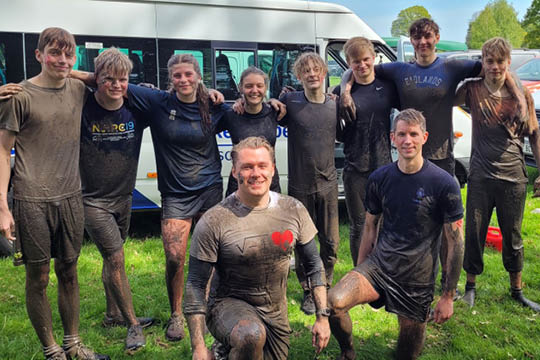 Pupils and Teachers covered in mud after the Dent Wizard Flying Colours Mud Run - AOB Mud Run - News