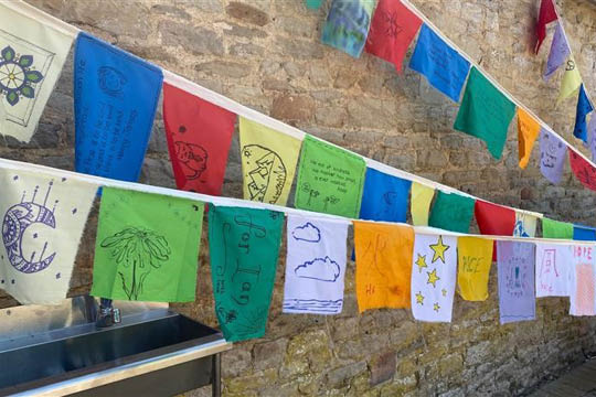 Global Citizen message flags hanging up during International Week at Cokethorpe School - News