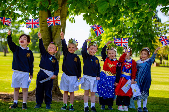 Prep School Children waving British Flags at the Prep School Sponsored Walk - Queens Platinum Jubilee Celebrations - News